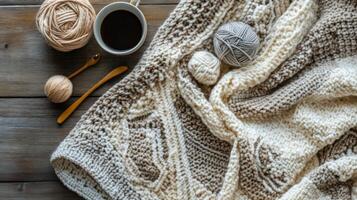 Cozy warm drinks and knitting supplies on a textured blanket in a sunlit indoor setting photo