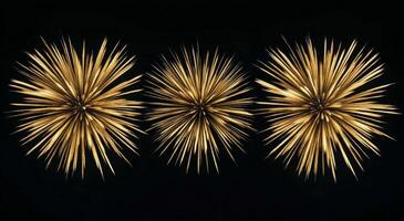 Three golden starburst decorations against a black background for elegant home decor photo