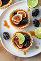 Delicious fruit tart with figs, blackberries, and lime on a wooden table photo