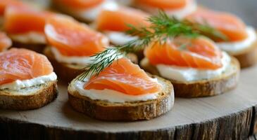 Delicious canapes with smoked salmon and cream cheese on rustic wooden platter photo