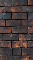 Textured dark brick wall with rusty highlights showing age and character in an urban setting photo
