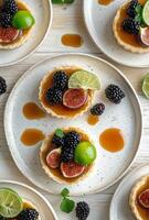 Delicious fruit tart with figs, blackberries, and lime on a wooden table photo