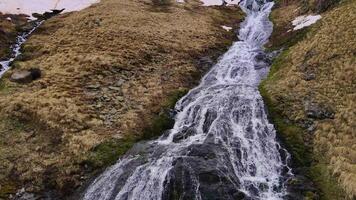 Aerial view of the flow of water falling from the volcanic cliffs video
