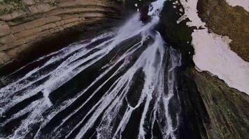 Stream of Terskol waterfall from the drone. Top down view video