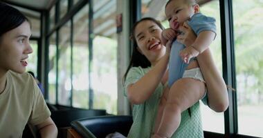 Footage of handheld shot, Two happy women having fun playing with a little boy in a coffee shop. Family enjoying time together. Happy lifestyle. video
