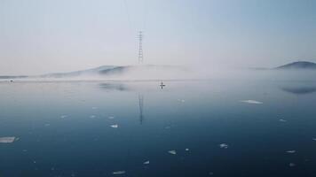 Drone view of a sup surfer floats through the ice capturing serenity. video