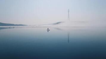 Drone view of a sup surfer floats through the ice capturing serenity. video