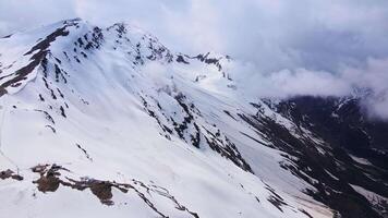 Aerial view of the Cheget mountain slope in spring. Cableway video