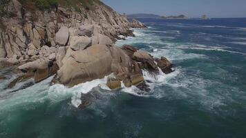 View from a droneon a stone cape washed by strong waves video