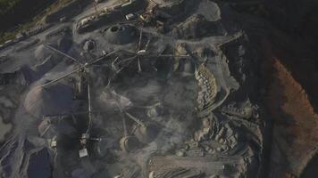 Big crusher working with rubble at a quarry, moving it on a line. video