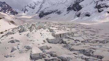 Cracks and blocks of ice on the glacier high in the mountains video