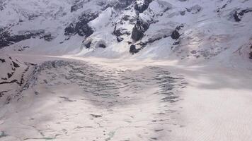 Cracks and blocks of ice on the glacier high in the mountains video