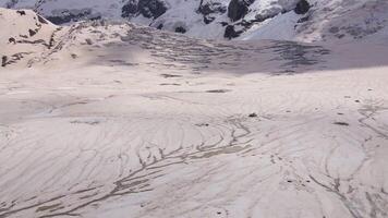 Cracks and blocks of ice on the glacier high in the mountains video