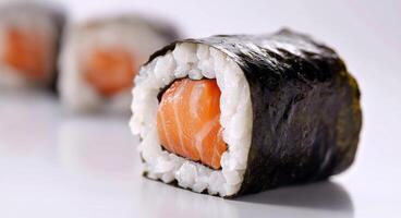 Sushi rolls featuring fresh salmon, rice, and seaweed arranged on a minimalist plate photo