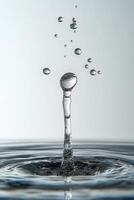 Water droplets create a stunning splash formation in a calm pool during bright daylight photo