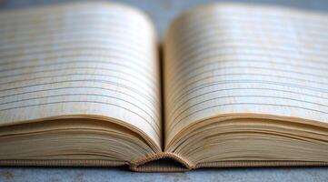 A close-up view of an open notebook resting on a wooden surface in soft natural light photo