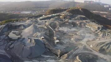 Big crusher working with rubble at a quarry, moving it on a line. video