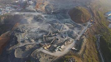 Big crusher working with rubble at a quarry, moving it on a line. video
