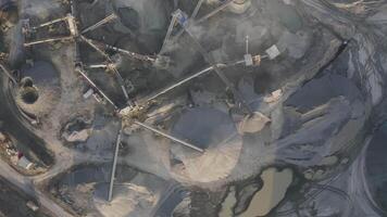 Big crusher working with rubble at a quarry, moving it on a line. video