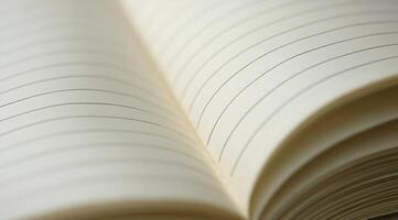 A close-up view of an open notebook resting on a wooden surface in soft natural light photo