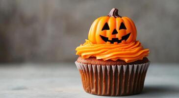 Festively decorated Halloween cupcakes with orange frosting and pumpkin toppers on a table photo