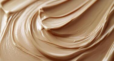 Creamy beige texture swirls in a close-up view showcasing smoothness and richness photo