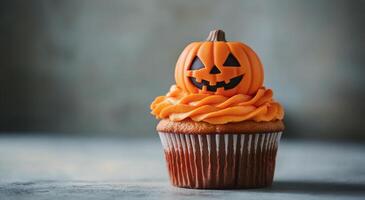 Festively decorated Halloween cupcakes with orange frosting and pumpkin toppers on a table photo