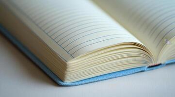 A close-up view of an open notebook resting on a wooden surface in soft natural light photo