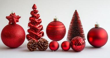 Festive collection of red Christmas ornaments arranged on a white surface for holiday decoration photo