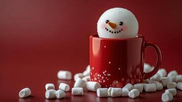 Cheerful snowman decoration in a red mug surrounded by marshmallows on a festive backdrop photo