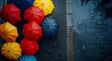 Colorful umbrellas scattered on a rainy street in an urban setting during a winter day photo