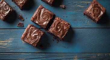 Delicious homemade brownies arranged on a rustic blue wooden table in afternoon light photo