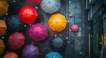 Colorful umbrellas scattered on a rainy street in an urban setting during a winter day photo