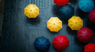 Colorful umbrellas scattered on a rainy street in an urban setting during a winter day photo