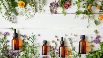 Herbal essence bottles surrounded by fresh flowers and herbs on a wooden table in natural light photo