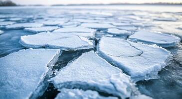 Cracked ice formations on a frozen lake during winter's twilight photo