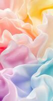Colorful ruffled fabric in soft pastels creating a dreamy texture in warm light photo