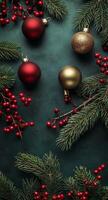 Festive holiday decor with ornaments and greenery on a dark green background photo