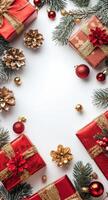 Festive holiday decorations with red gifts and ornaments arranged around a blank space photo