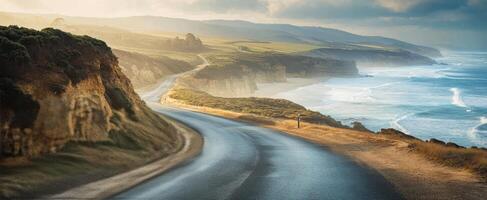 Scenic coastal highway overlooking the ocean during a sunny day in the afternoon photo