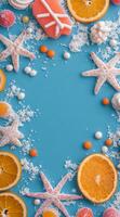 Colorful arrangement of oranges and candies with starfish on a blue background photo