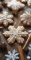 Homemade snowflake-shaped cookies decorated with icing on a wooden surface with spices photo