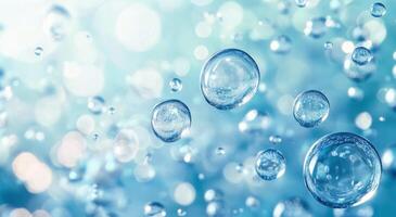 Translucent water droplets create a serene background with shimmering highlights in blue tones photo