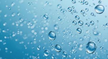 Translucent water droplets create a serene background with shimmering highlights in blue tones photo