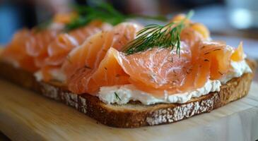 Fresh salmon on toasted bread topped with dill and cream cheese garnished elegantly photo