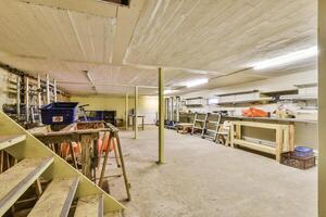 A room with a ladder and a bunch of tools photo