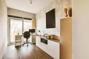 A home office with a desk, chair and a window photo