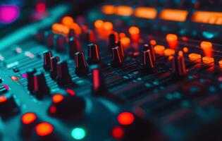 Close-up view of an illuminated sound mixing console with vibrant buttons and dials at night photo