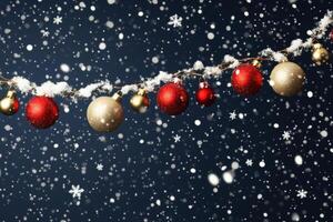 Colorful Christmas ornaments hanging on a snowy evening with sparkling snowflakes falling down photo