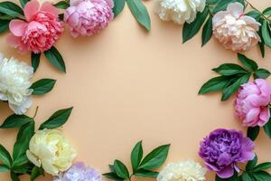 Colorful peonies and leaves arranged in a circular frame on a soft background photo